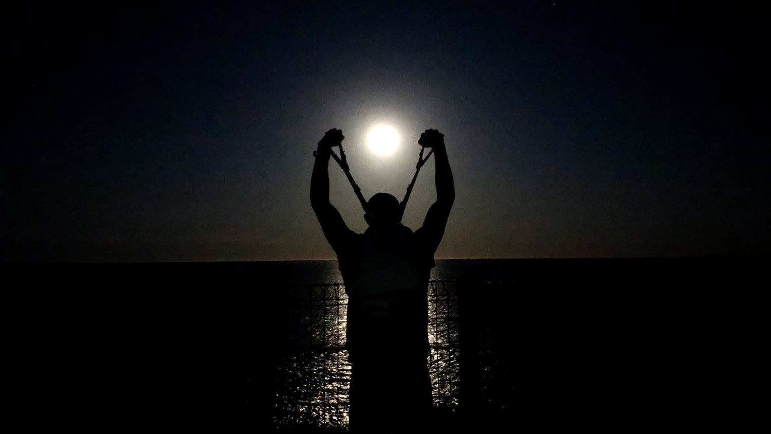 Man lifting backpack off his shoulders, signifying lifting the weight of the world.