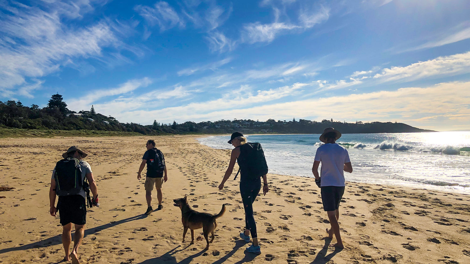 Four people rucking on the beach